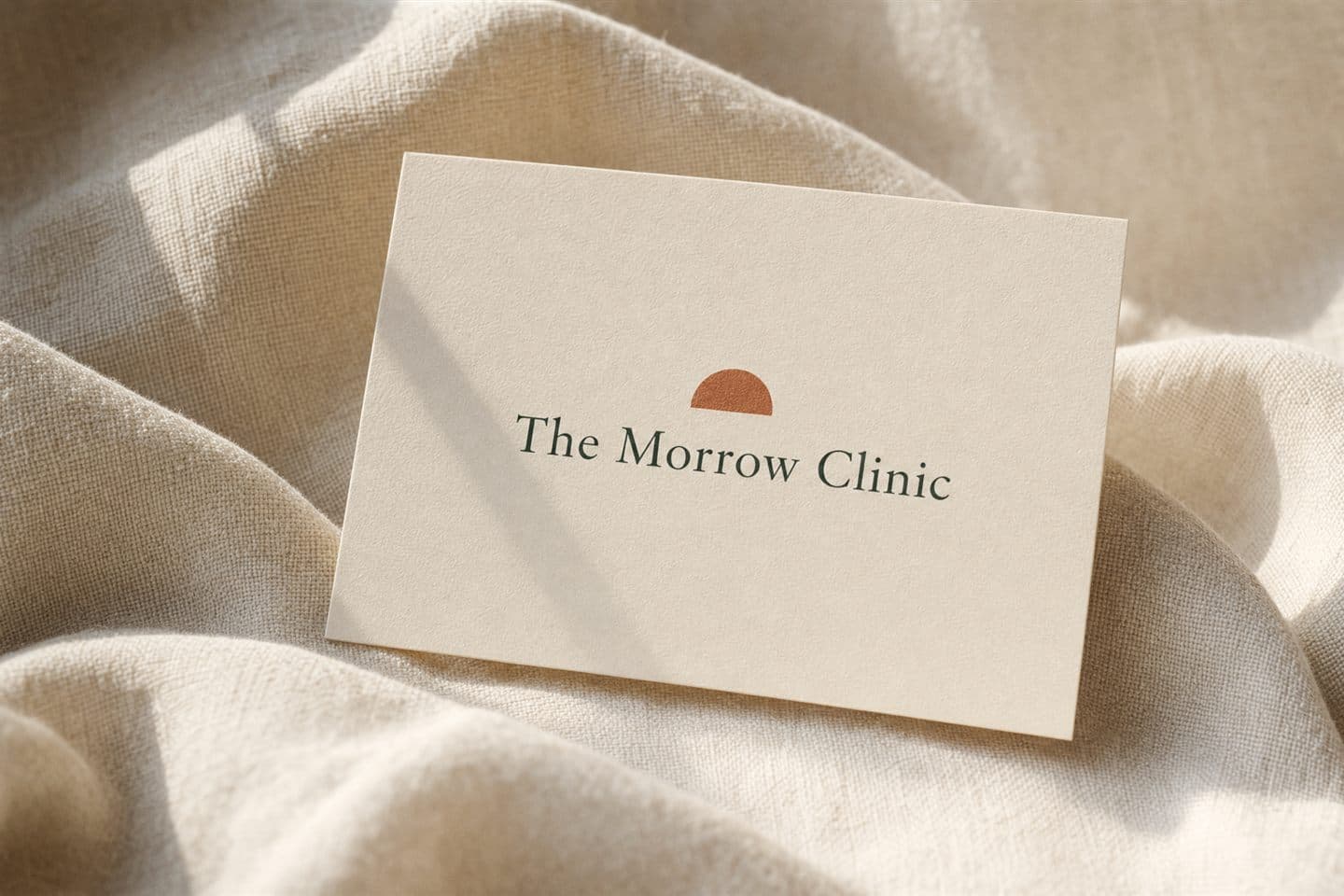 The Morrow Clinic gift card resting on linen in soft morning light